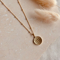 Gold hammered disc necklace
